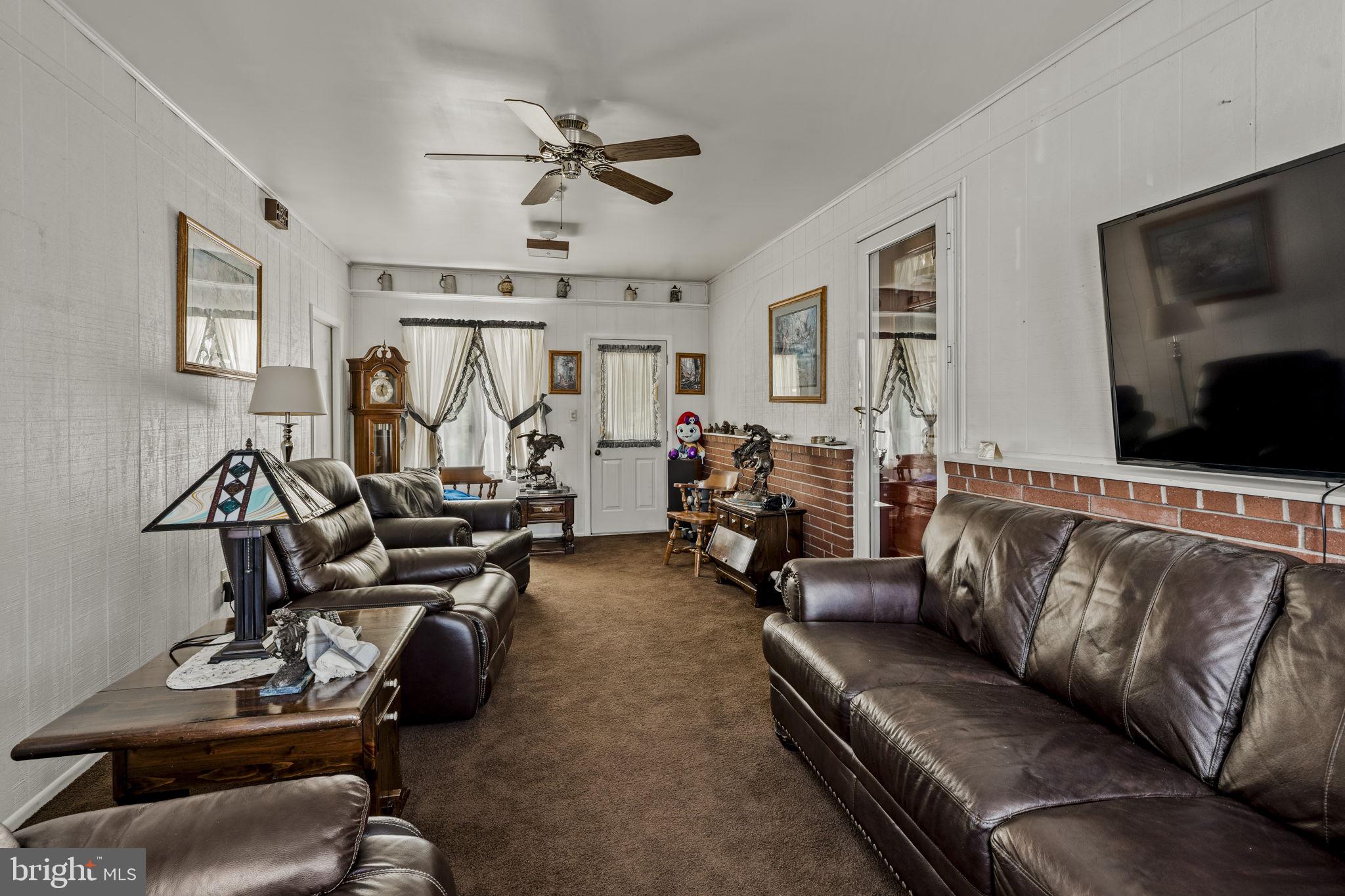 462 Sawmill Road New Providence, PA 17560 - Photo 21 of 26 a living room with furniture gym equipment and a flat screen tv