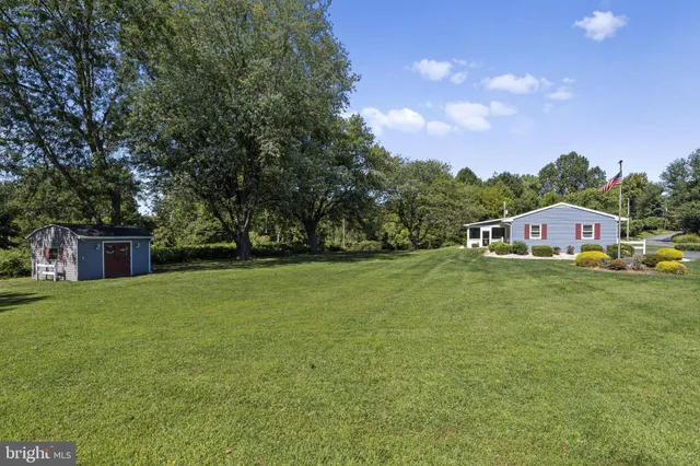 a front view of house with yard and trees