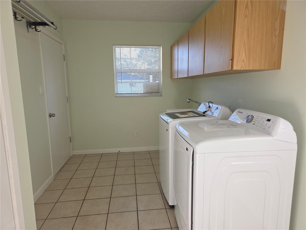 17026 Highway 54 Lutz, FL 33558 - Photo 12 of 13 a utility room with a sink a cabinetry and a window