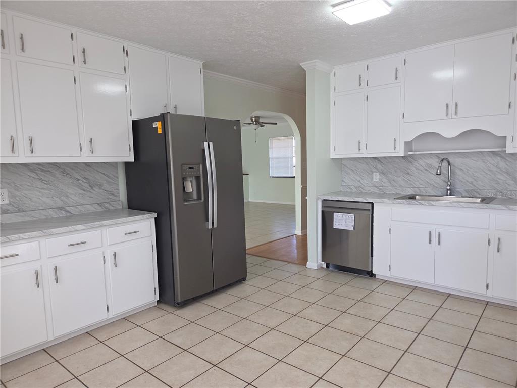 17026 Highway 54 Lutz, FL 33558 - Photo 5 of 13 a kitchen with stainless steel appliances granite countertop a refrigerator sink and cabinets