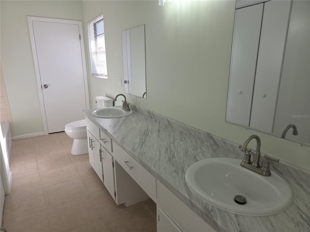 17026 Highway 54 Lutz, FL 33558 - Photo 10 of 13 a bathroom with a granite countertop sink and a mirror