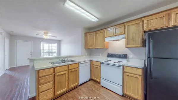 a kitchen with a sink stove and refrigerator
