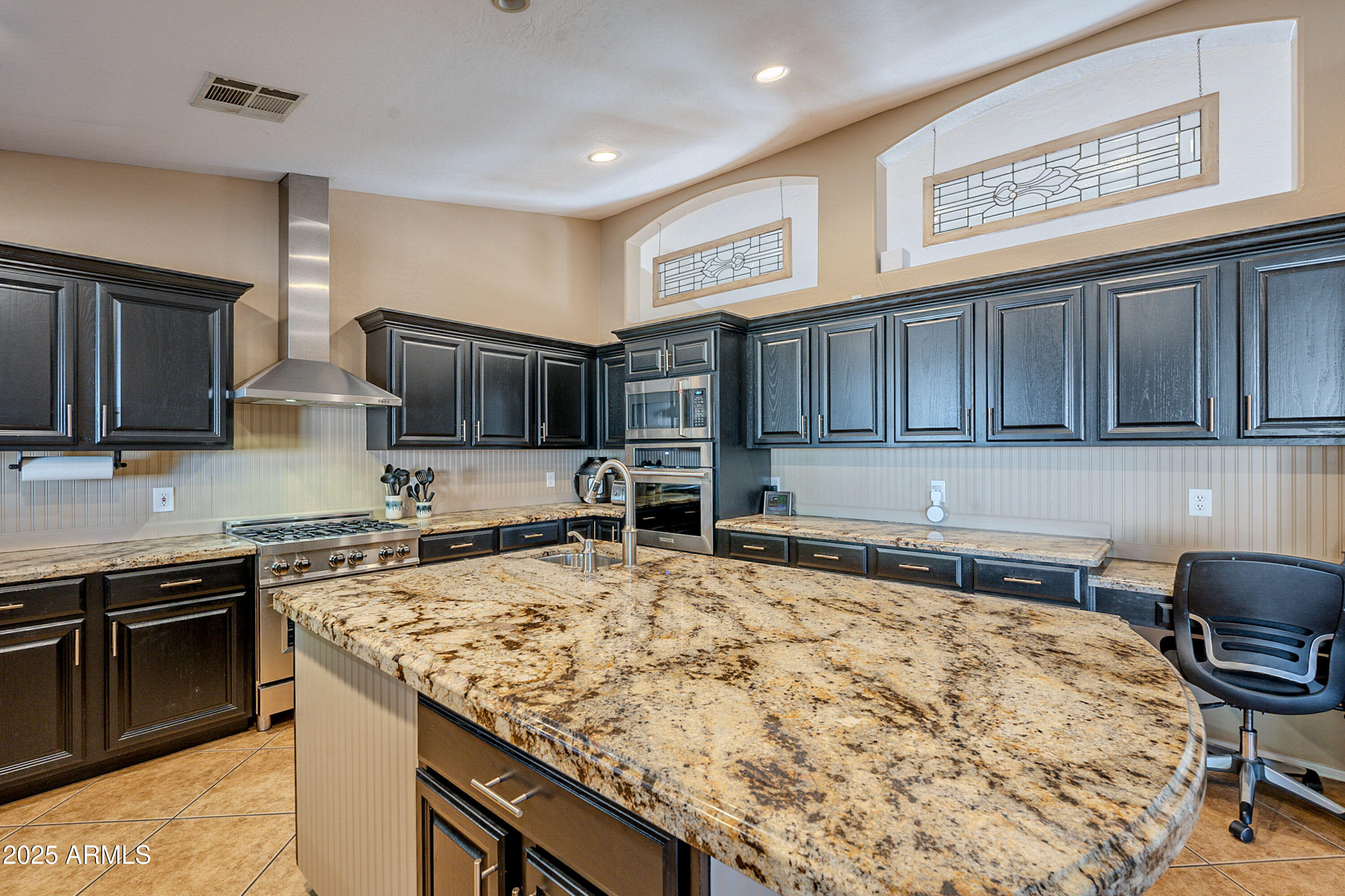3464 North Ashbrook Mesa, AZ 85213 - Photo 11 of 63 a kitchen with kitchen island granite countertop wooden cabinets a stove top oven a sink and dishwasher