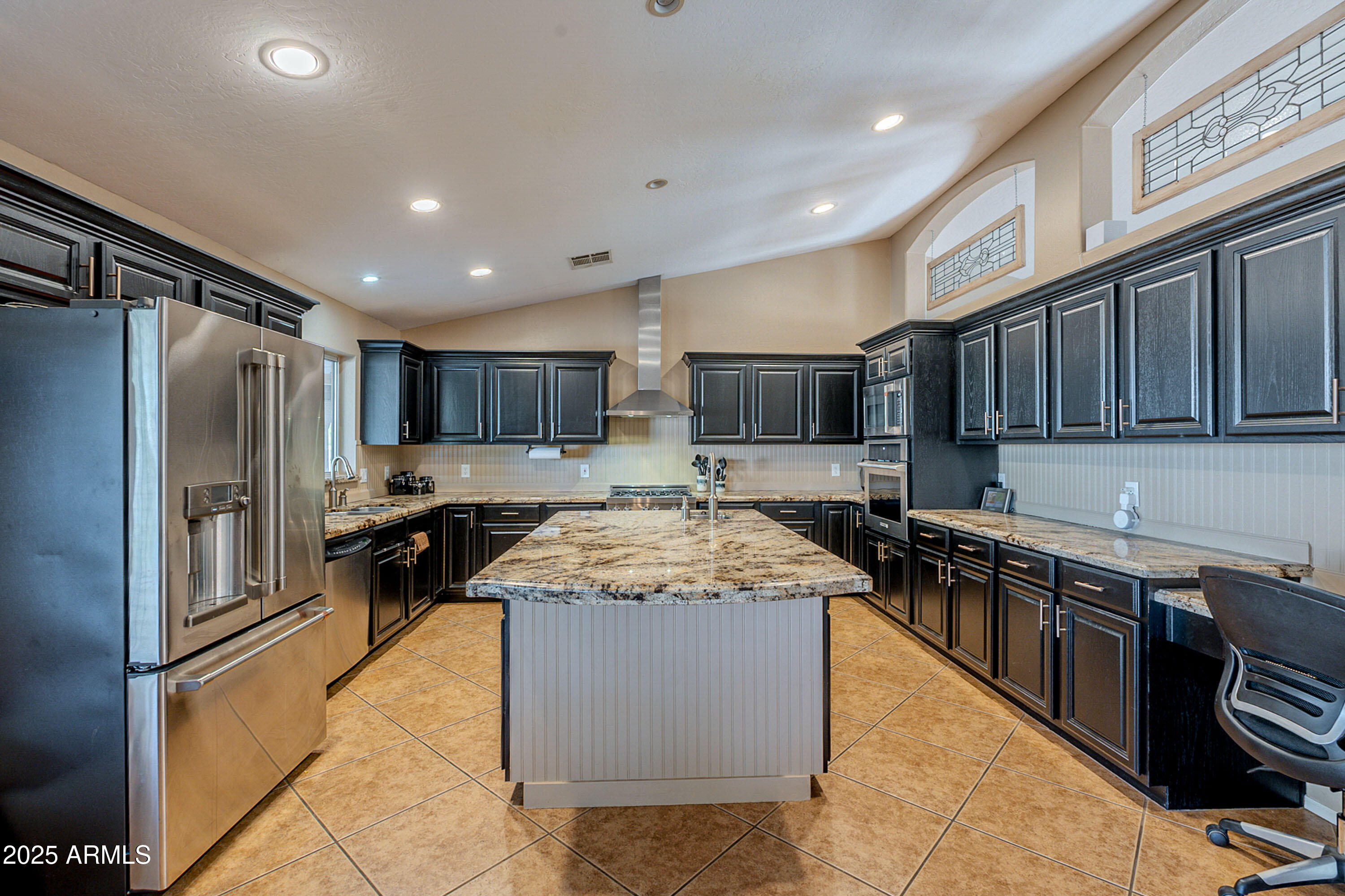 3464 North Ashbrook Mesa, AZ 85213 - Photo 12 of 63 a kitchen with stainless steel appliances granite countertop a stove top oven a sink and a refrigerator