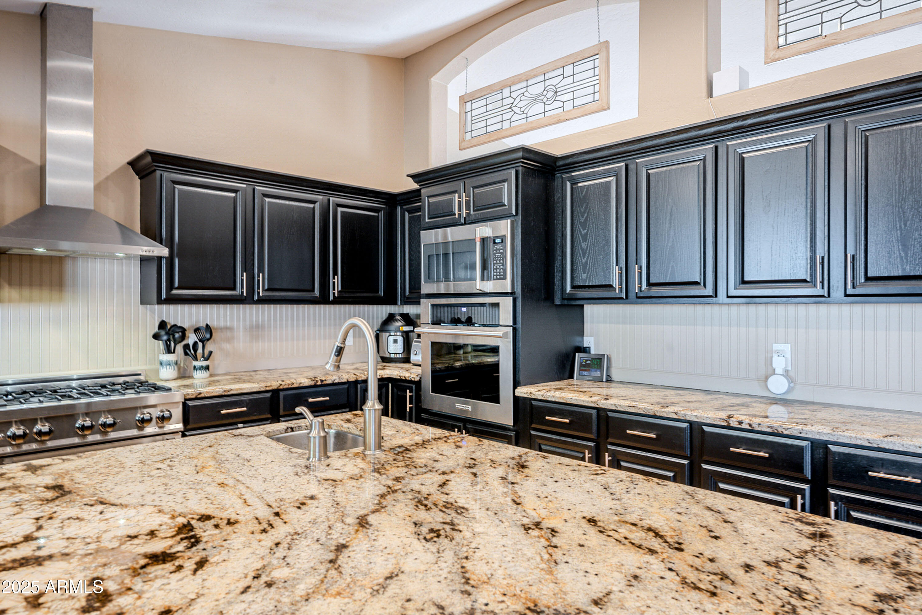 3464 North Ashbrook Mesa, AZ 85213 - Photo 13 of 63 a kitchen with stainless steel appliances granite countertop a stove and cabinets