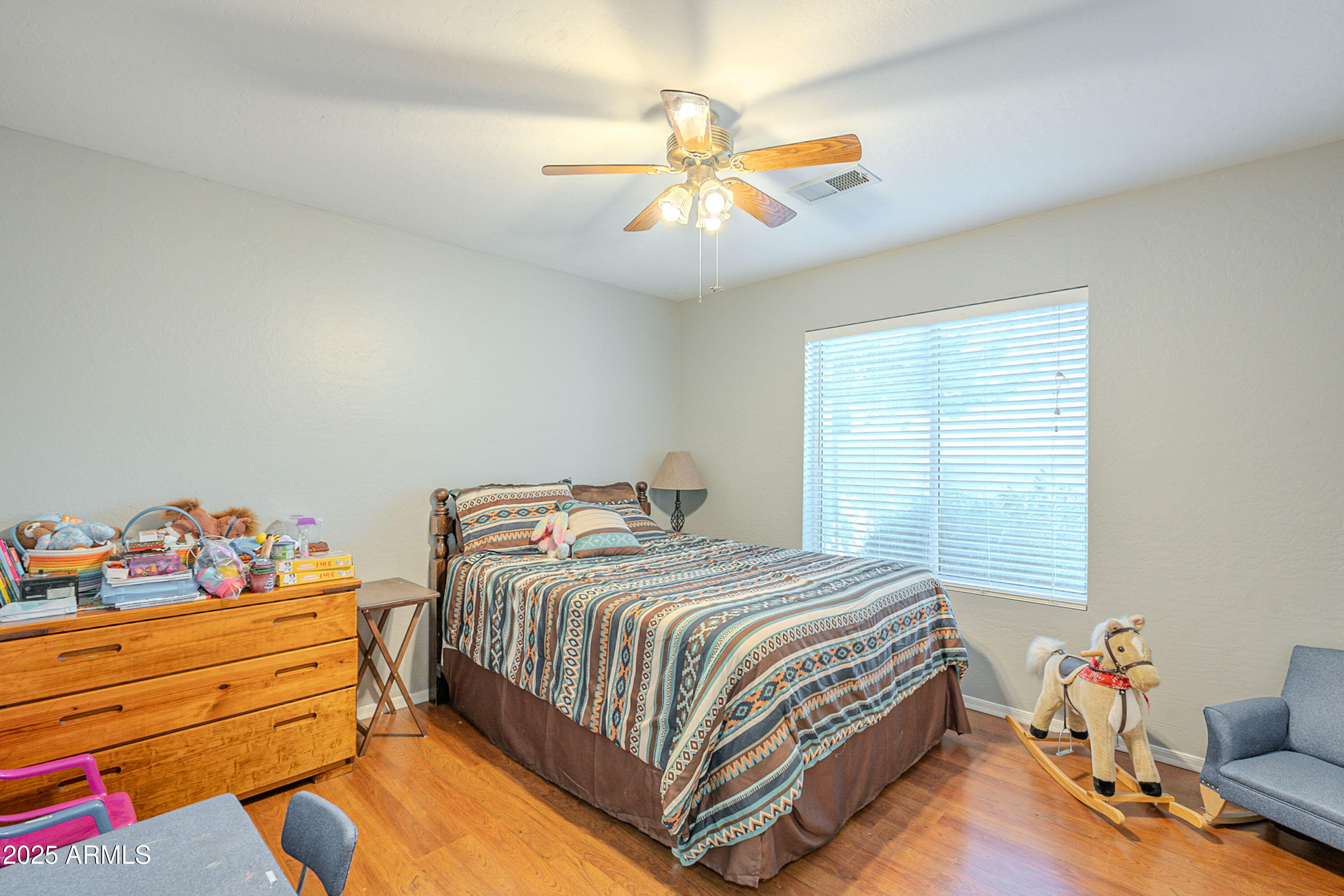 3464 North Ashbrook Mesa, AZ 85213 - Photo 16 of 63 a bedroom with a bed and a chandelier