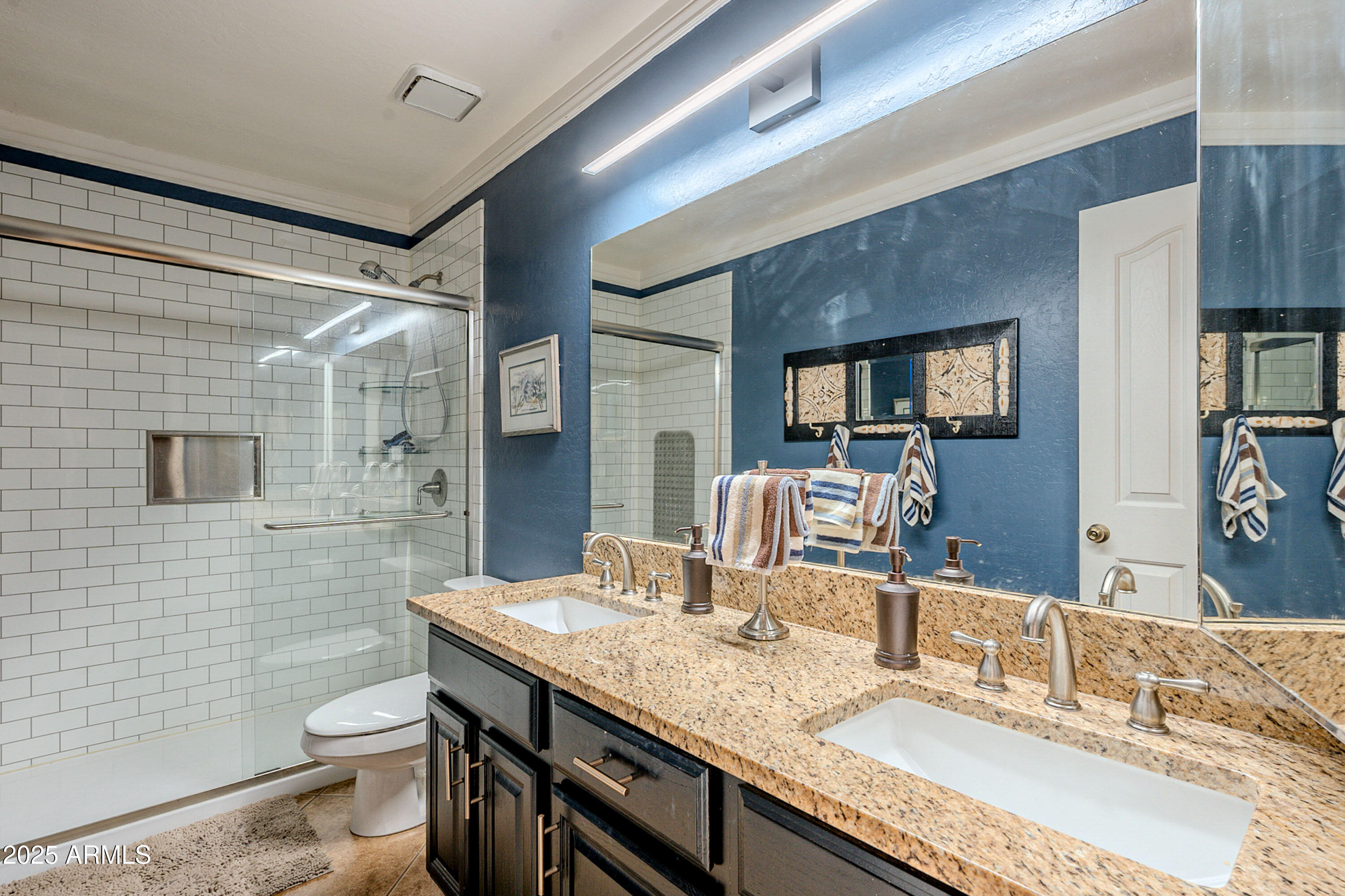 3464 North Ashbrook Mesa, AZ 85213 - Photo 18 of 63 a bathroom with a granite countertop sink a toilet a mirror and shower