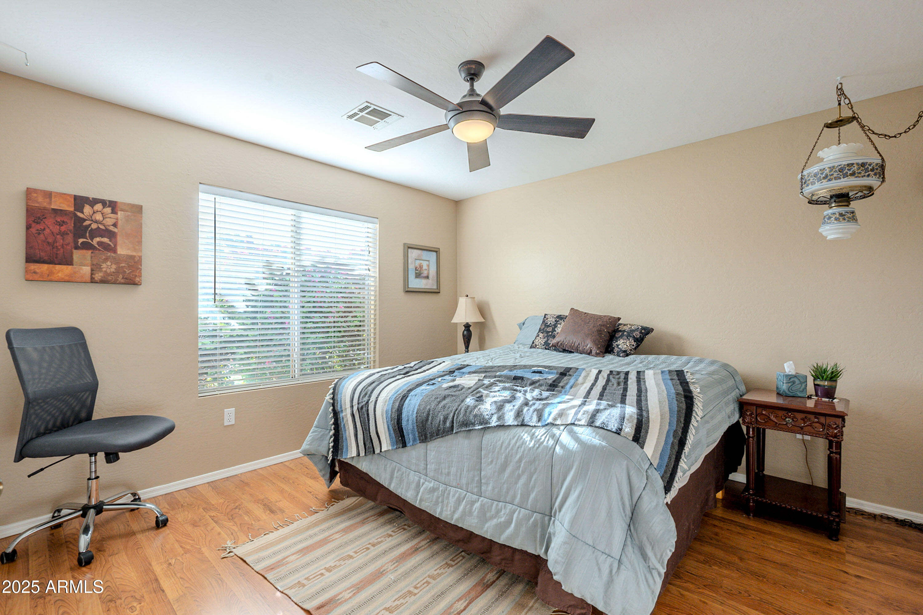 3464 North Ashbrook Mesa, AZ 85213 - Photo 19 of 63 a bed sitting in a bedroom next to a window