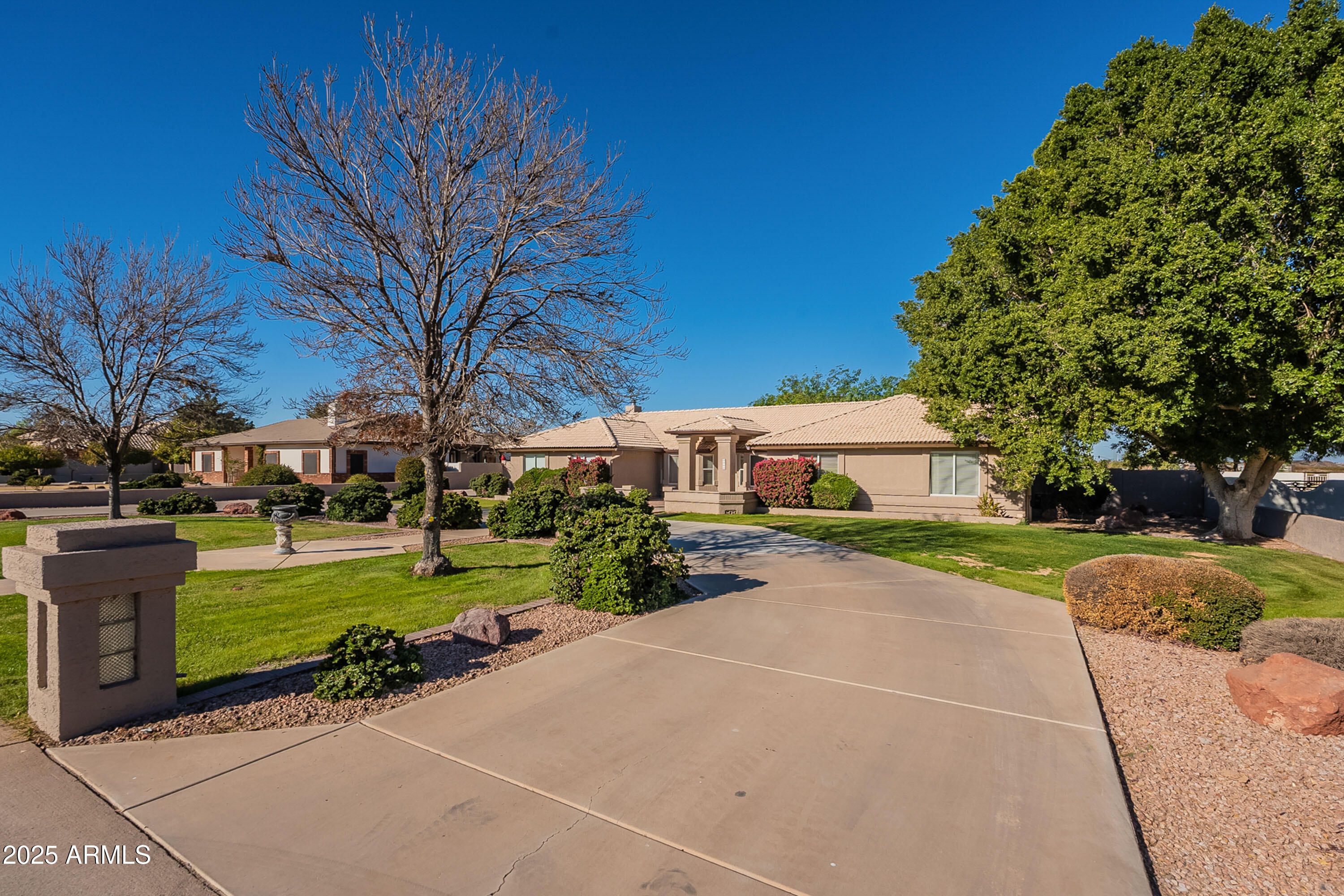 3464 North Ashbrook Mesa, AZ 85213 - Photo 3 of 63 a front view of a house with a yard and trees
