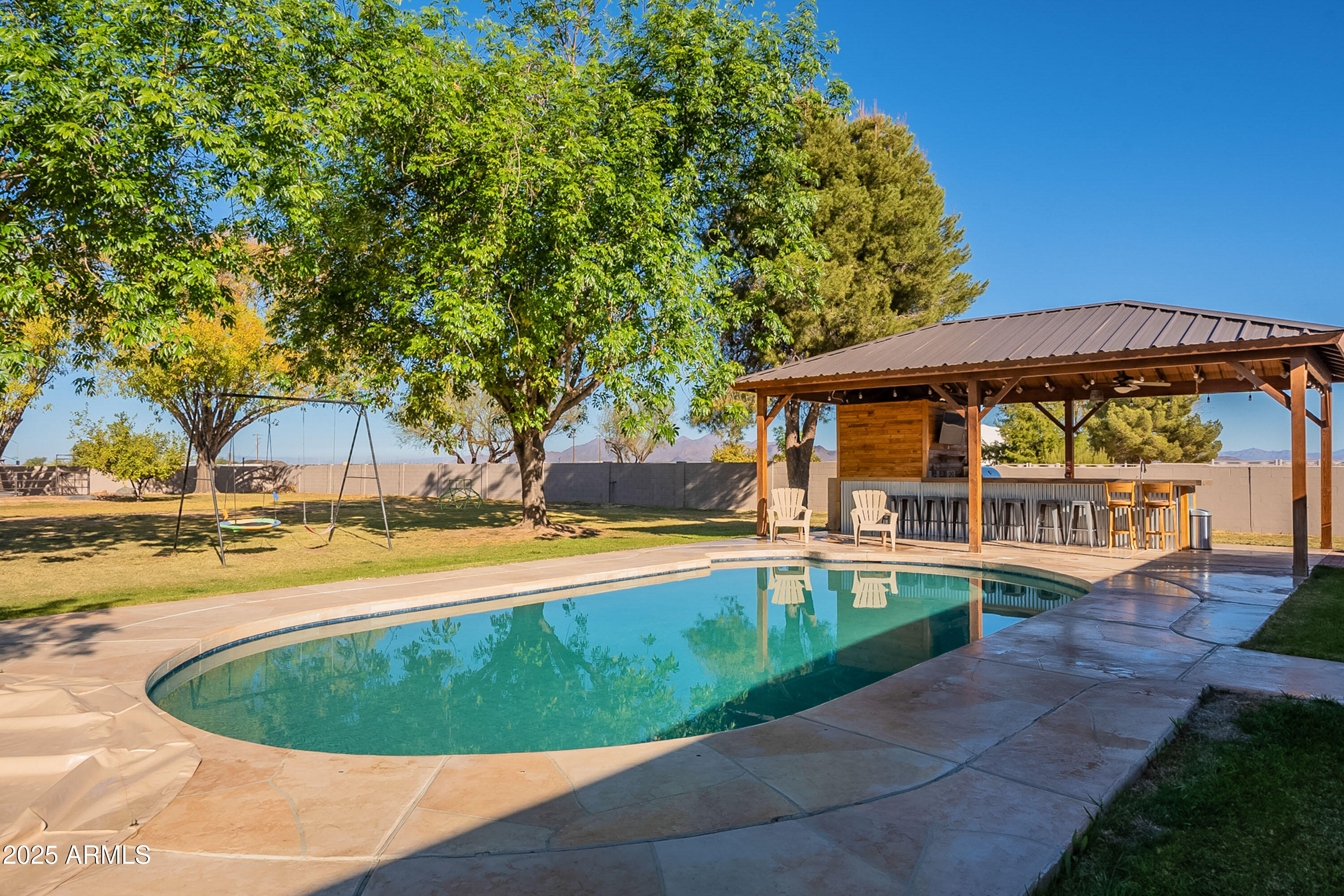 3464 North Ashbrook Mesa, AZ 85213 - Photo 52 of 63 a view of a swimming pool with an outdoor space and seating area