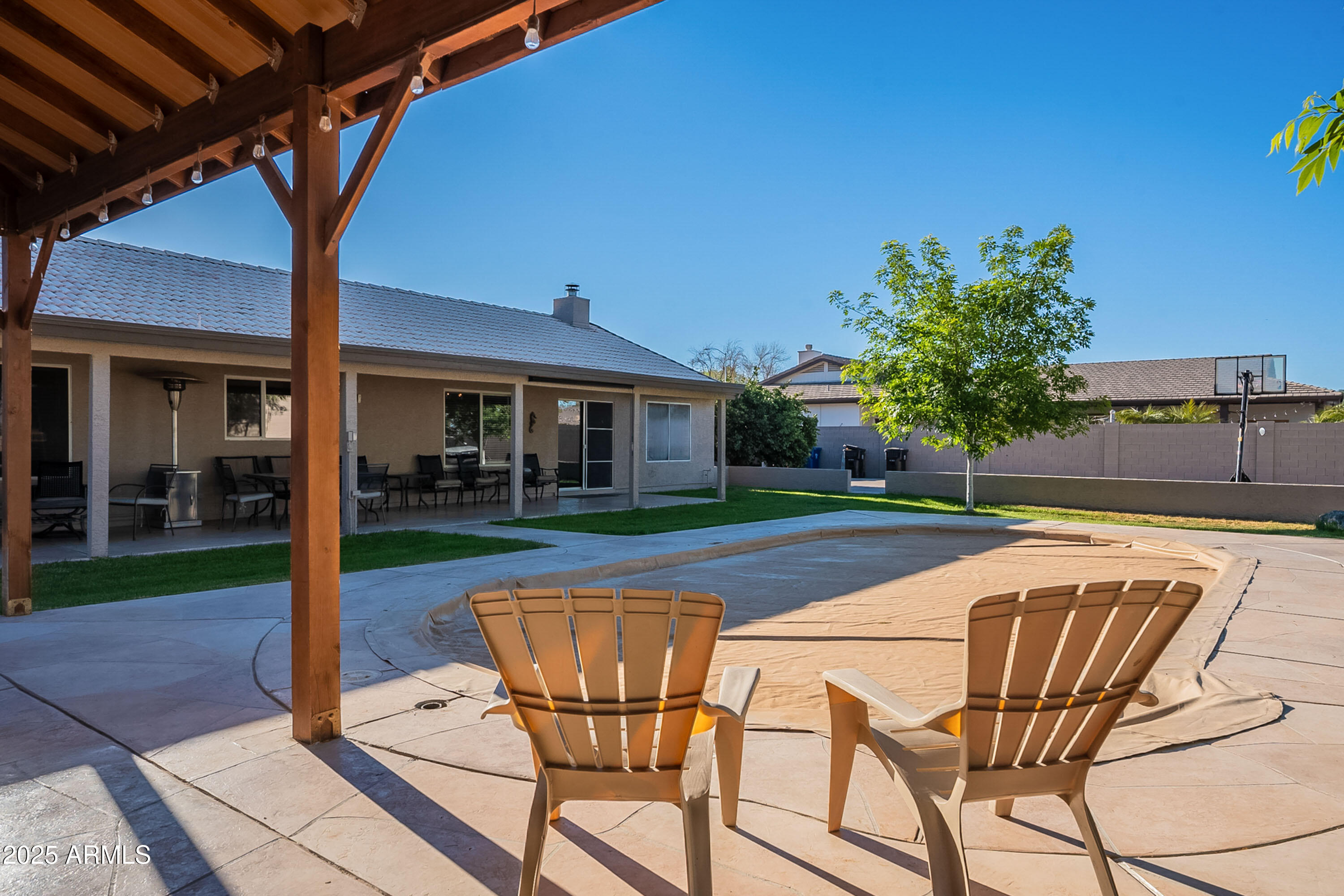 3464 North Ashbrook Mesa, AZ 85213 - Photo 62 of 63 a patio with a table and chairs and potted plants