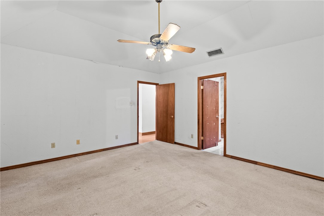 5309 Timbergate Drive Corpus Christi, TX 78413 - Photo 12 of 29 an empty room with closet and a chandelier fan