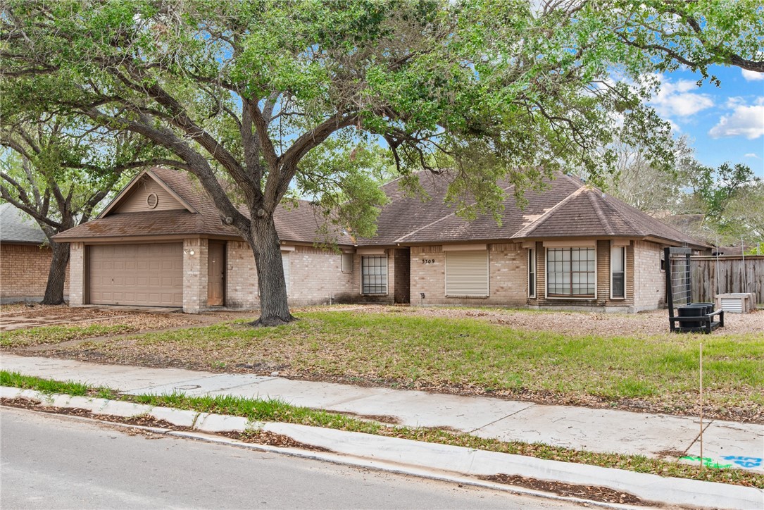 5309 Timbergate Drive Corpus Christi, TX 78413 - Photo 2 of 29 a white house that has a tree in front of it