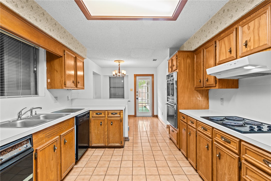 5309 Timbergate Drive Corpus Christi, TX 78413 - Photo 22 of 29 a kitchen with a sink stove and cabinets