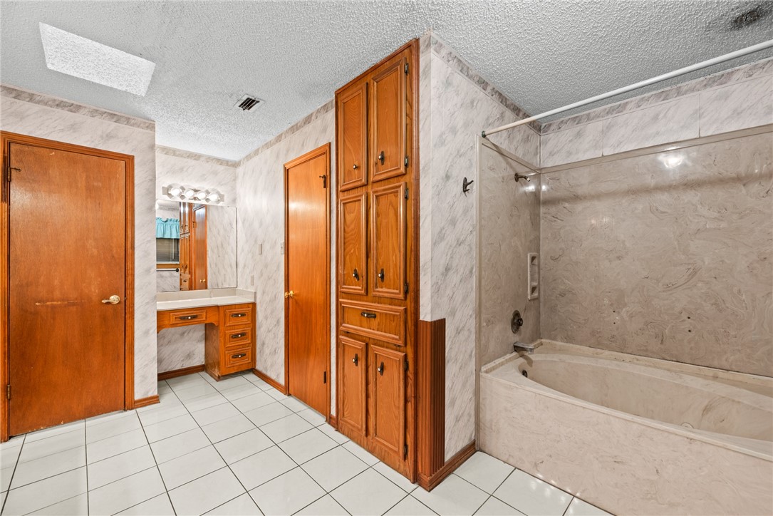 5309 Timbergate Drive Corpus Christi, TX 78413 - Photo 24 of 29 a bathroom with a bathtub a sink and a shower