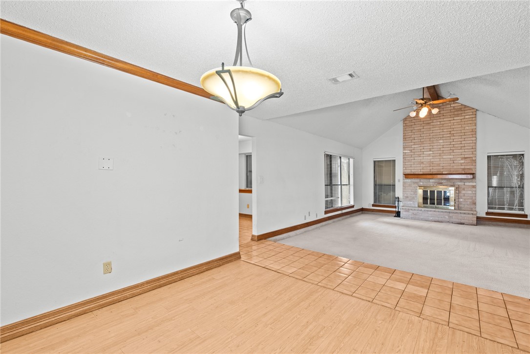 5309 Timbergate Drive Corpus Christi, TX 78413 - Photo 3 of 29 a view of a livingroom with a fireplace cabinets and a ceiling fan