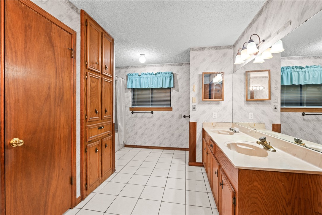 5309 Timbergate Drive Corpus Christi, TX 78413 - Photo 6 of 29 a bathroom with a sink a mirror and a shower