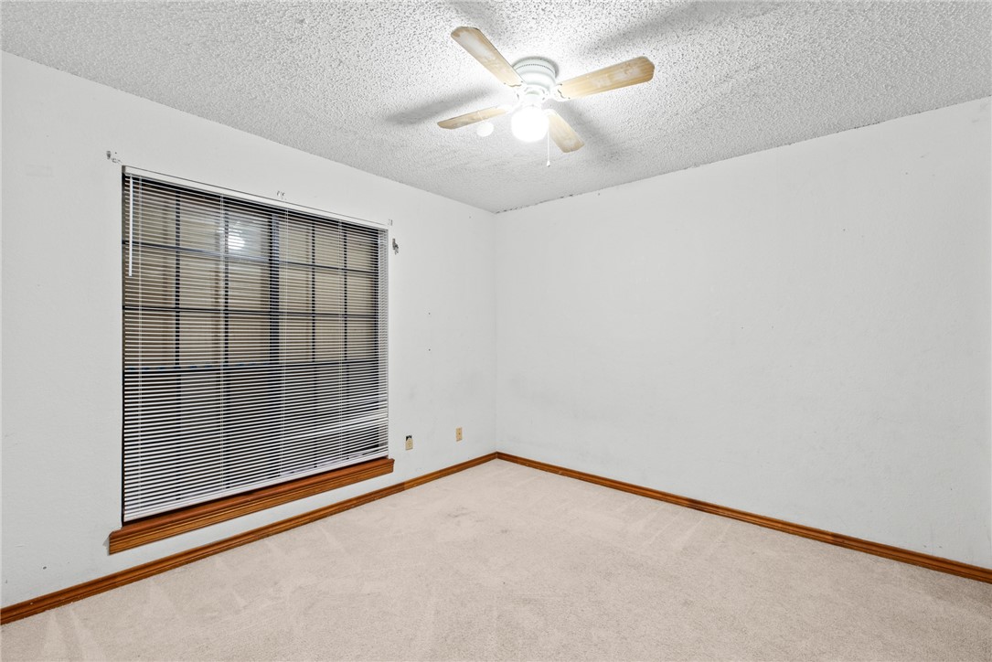5309 Timbergate Drive Corpus Christi, TX 78413 - Photo 8 of 29 an empty room with a ceiling fan and a window
