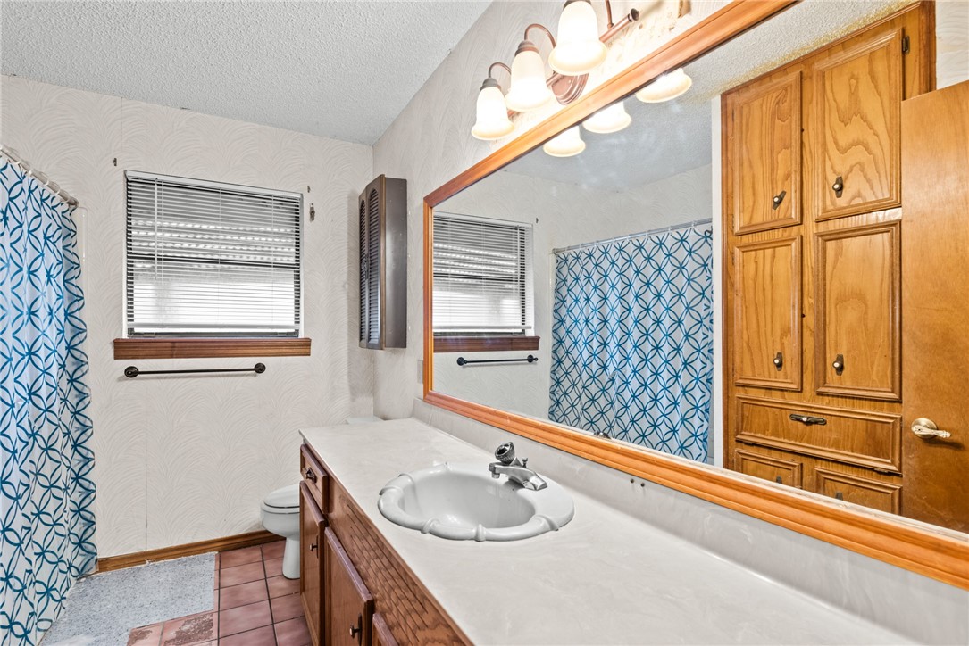 5309 Timbergate Drive Corpus Christi, TX 78413 - Photo 10 of 29 a bathroom with a granite countertop sink and a mirror