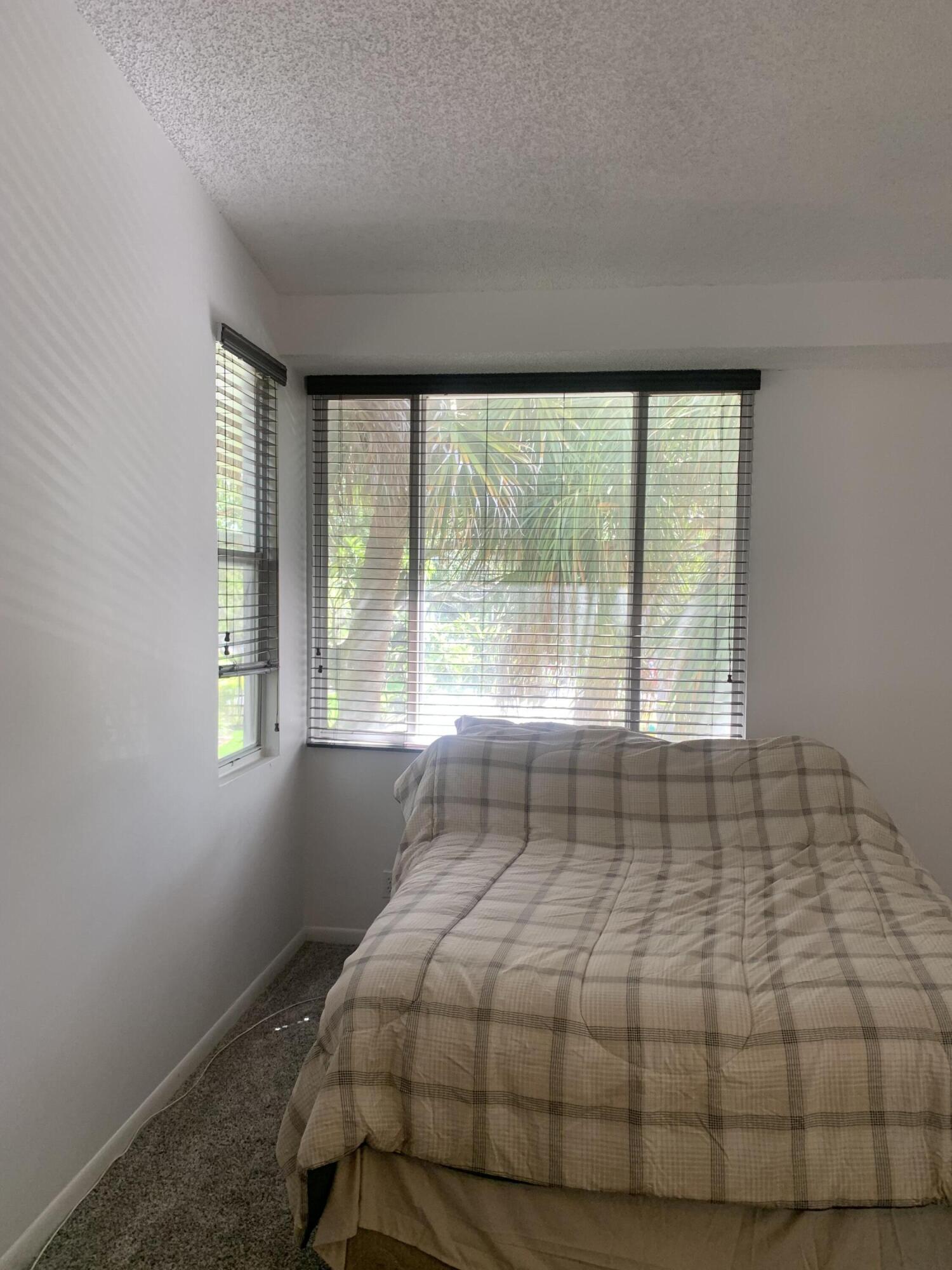 651 Lyons Road, Unit 10207 Coconut Creek, FL 33063 - Photo 18 of 38 primary bedroom window view