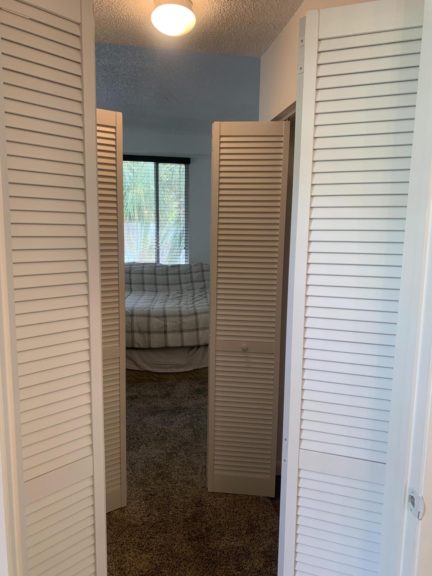 651 Lyons Road, Unit 10207 Coconut Creek, FL 33063 - Photo 21 of 38 Hallway from the bathroom facing the bed