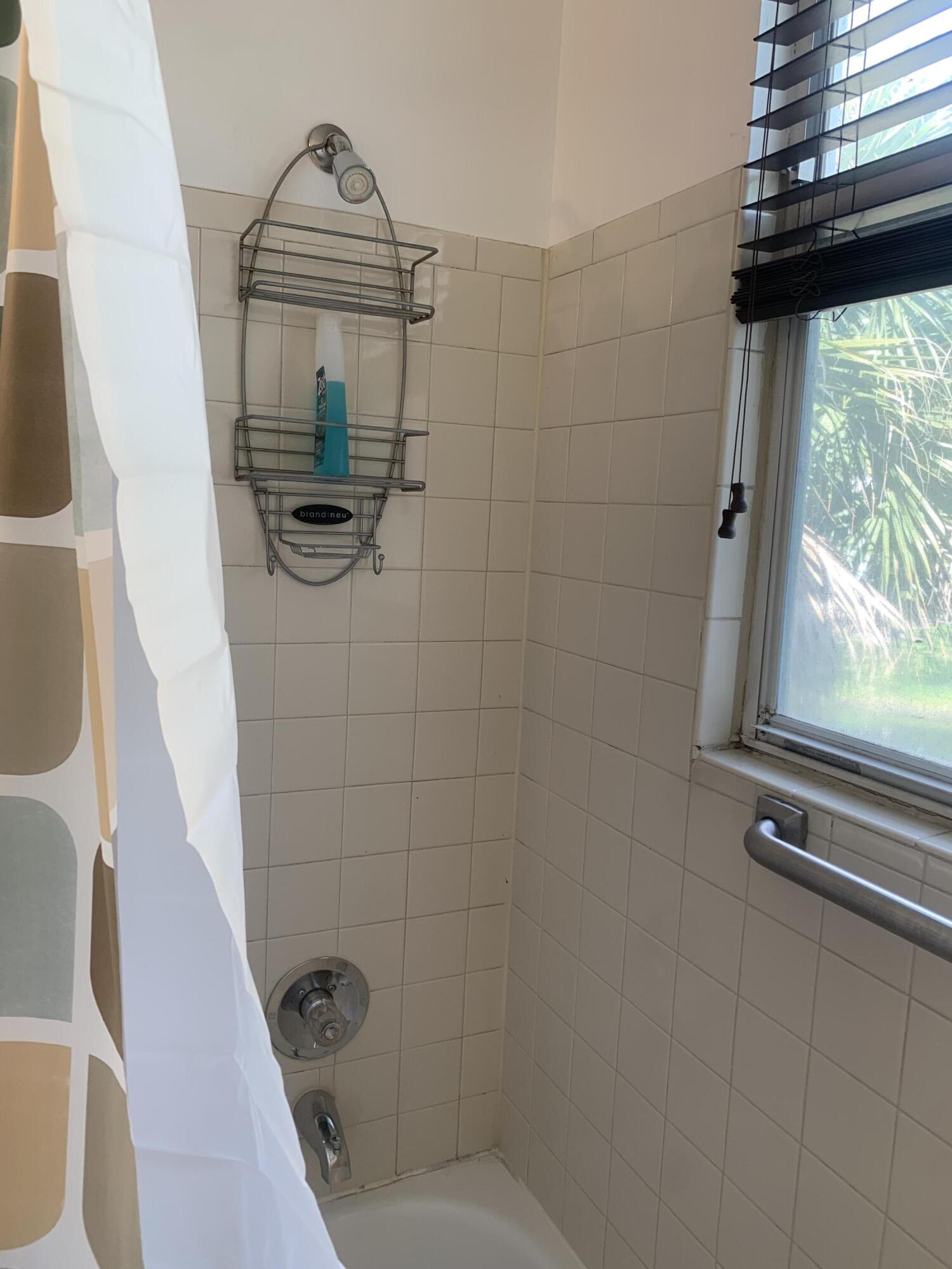 651 Lyons Road, Unit 10207 Coconut Creek, FL 33063 - Photo 26 of 38 Bathtub, shower head and spout