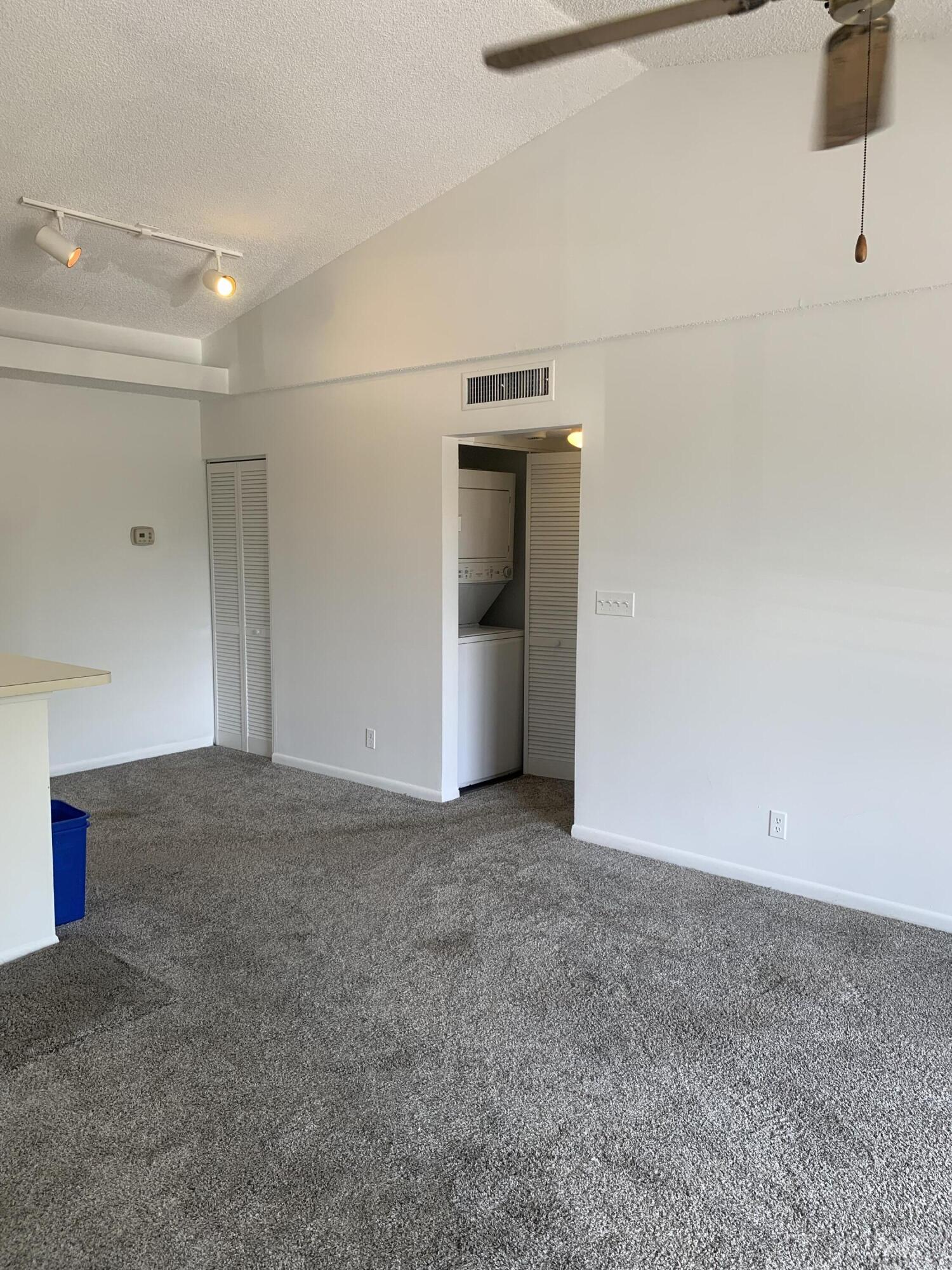 651 Lyons Road, Unit 10207 Coconut Creek, FL 33063 - Photo 5 of 38 Living room, dining area, and Hallway