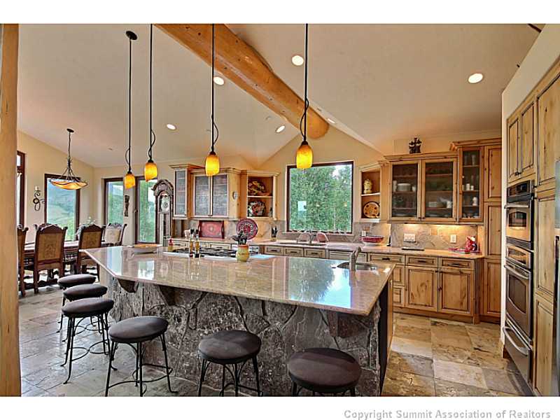2560 Hunter's Knob Road Silverthorne, CO 80498 - Photo 4 of 25 Kitchen. Moss rock surround on kitchen island with slab granite counter tops