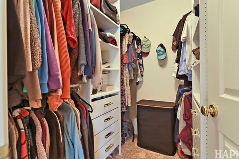 a view of walk in closet with clothes