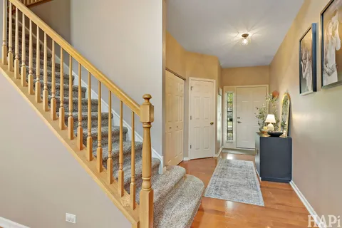 a view of an entryway with wooden floor and stairs