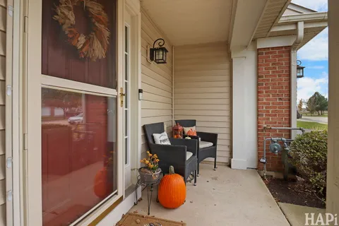 a backyard of a house with barbeque oven table and chairs