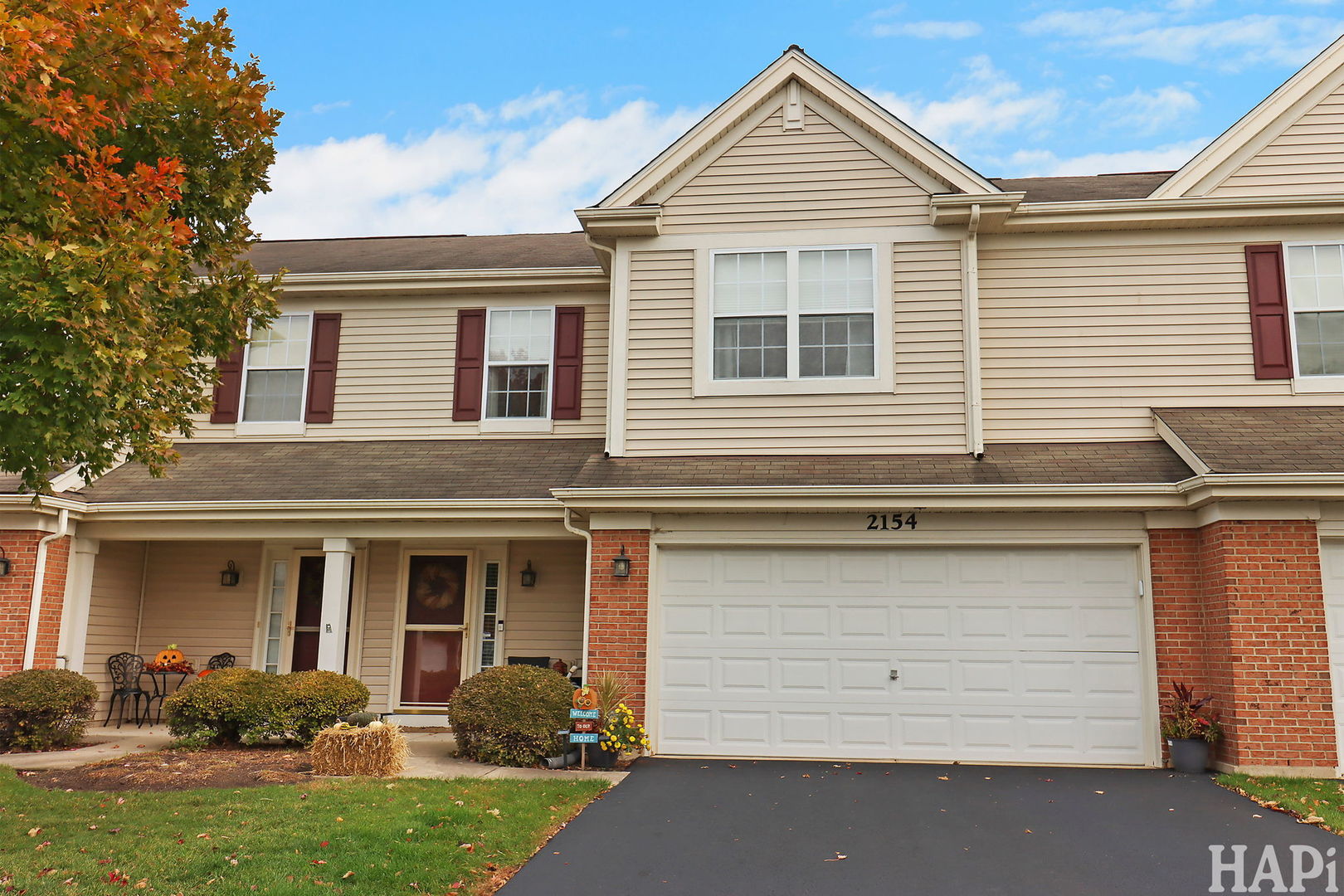 2154 Daybreak Drive Lake In The Hills, IL 60156 - Photo 24 of 29 a view of a white house with large windows and a yard