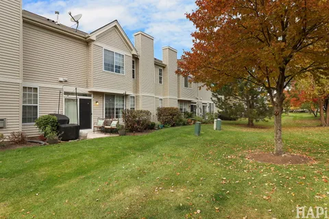 a view of a house with backyard and sitting area