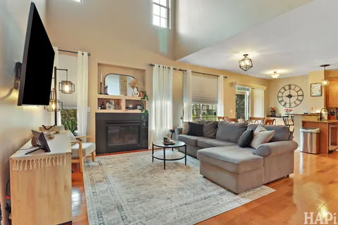 a living room with fireplace furniture and a flat screen tv