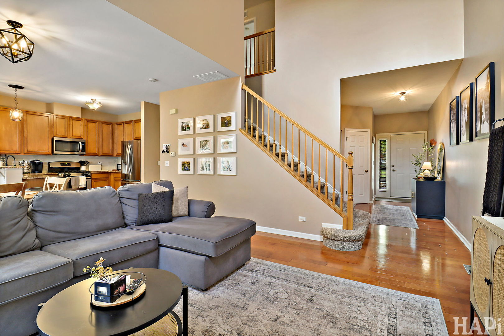 2154 Daybreak Drive Lake In The Hills, IL 60156 - Photo 6 of 29 a living room with furniture and a dining table with wooden floor
