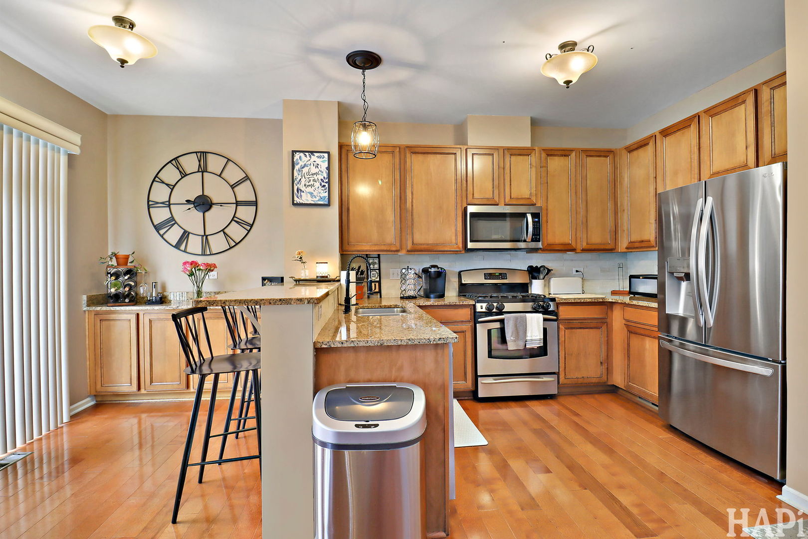 2154 Daybreak Drive Lake In The Hills, IL 60156 - Photo 9 of 29 a kitchen with granite countertop a refrigerator stove and microwave