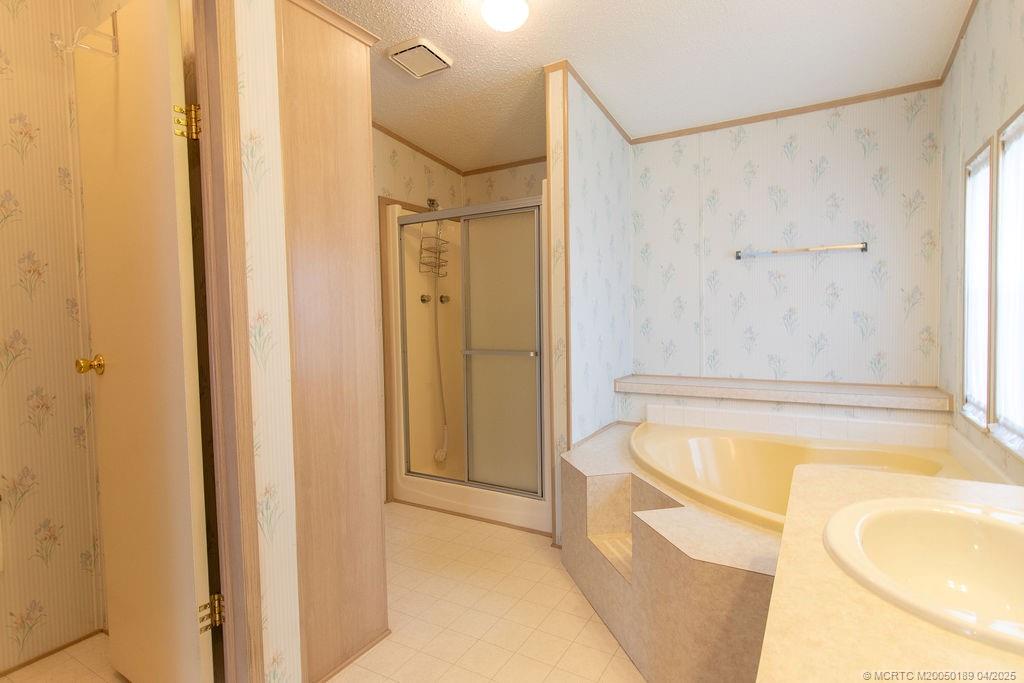 2500 Southwest Marquis Terrace Stuart, FL 34997 - Photo 17 of 20 a bathroom with a tub and shower