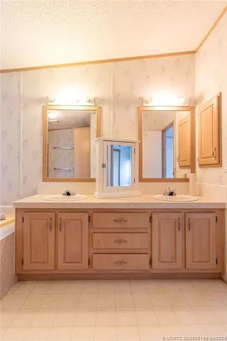 a spacious bathroom with a granite countertop tub and a sink