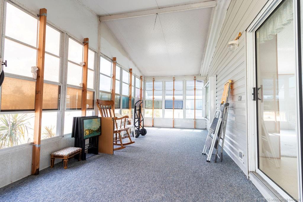 2500 Southwest Marquis Terrace Stuart, FL 34997 - Photo 4 of 20 a room with stairs and a large window