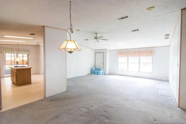a view of an empty room with window and cabinet