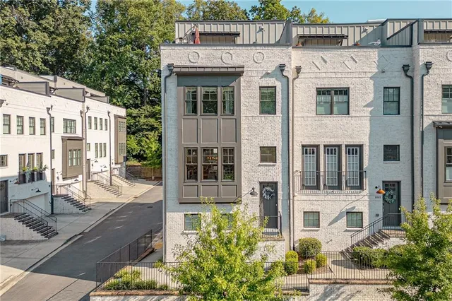 a front view of a residential apartment building with a yard