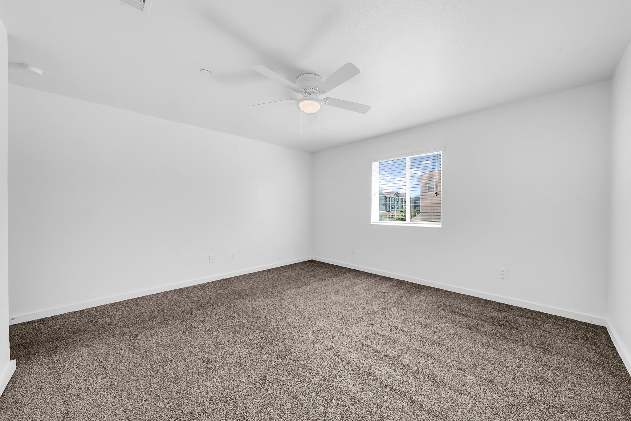21155 Gosling Road, Unit 24B Spring, TX 77388 - Photo 13 of 23 an empty room with a window and ceiling fan