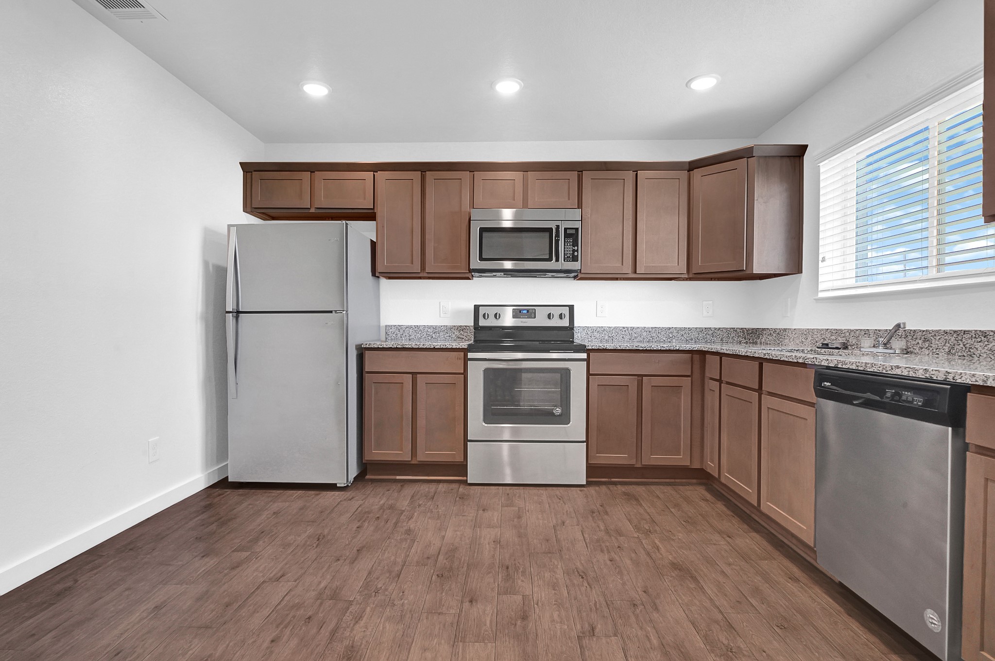 21155 Gosling Road, Unit 24B Spring, TX 77388 - Photo 10 of 23 a kitchen with a sink a refrigerator and a microwave