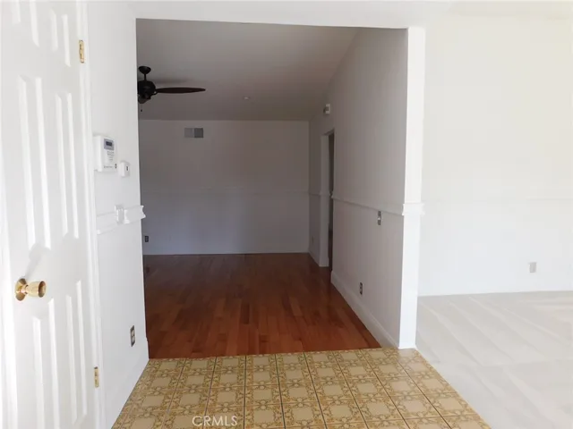 an empty room with a fireplace and window