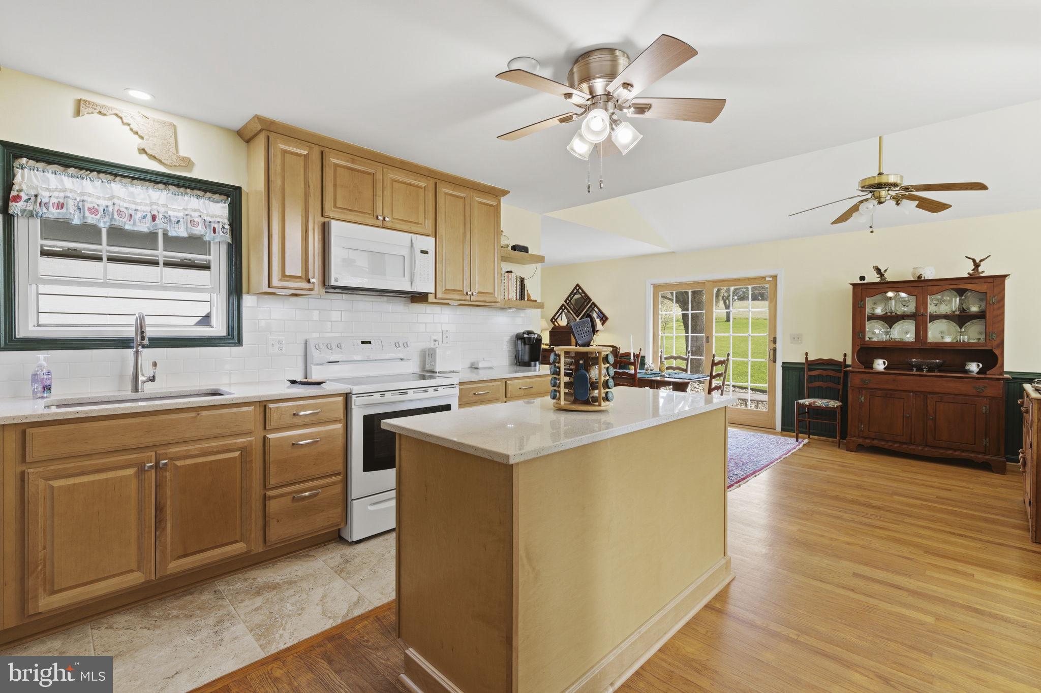 3831 Wilkinson Road Havre de Grace, MD 21078 - Photo 6 of 51 a large kitchen with stainless steel appliances granite countertop a sink dishwasher stove and oven with wooden floor