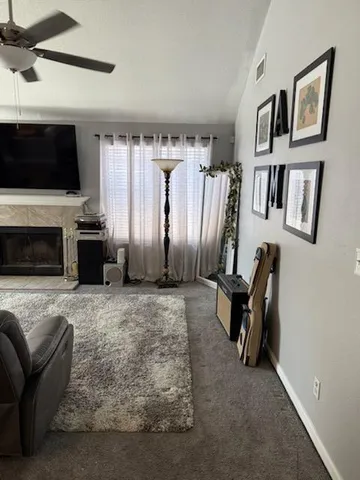 a living room with fireplace furniture and a flat screen tv