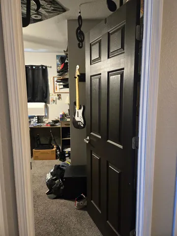 a bedroom with a bed dresser and a chandelier