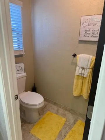 a room with a granite countertop sink and a mirror