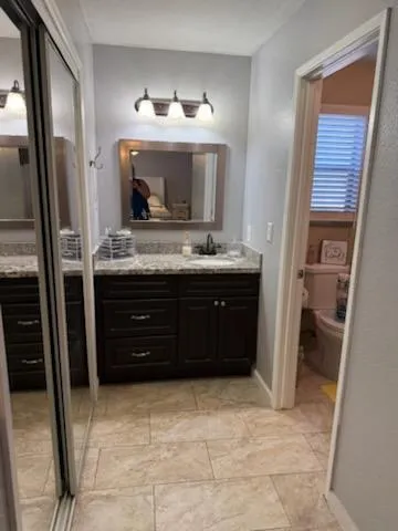 a view of kitchen with refrigerator and cabinets