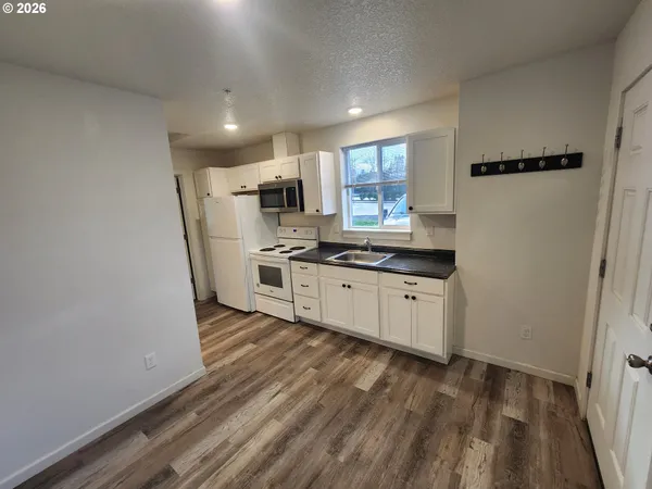 a kitchen with stainless steel appliances a refrigerator and a stove top oven